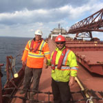 Crew boards the ladder as the American Fortitude sits at anchorage outside of Port Weller