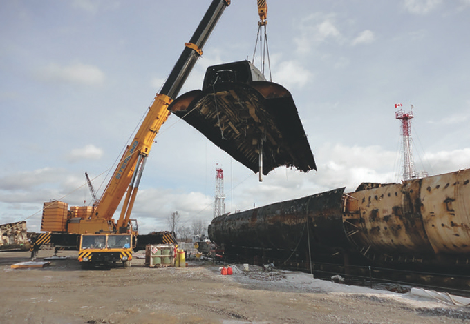 Marine Recycling Corporation removes the top section of a naval submarine during recycling operations.